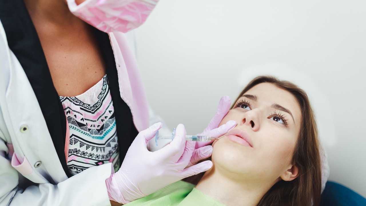 a girl taking collagen injection in her face by a doctor