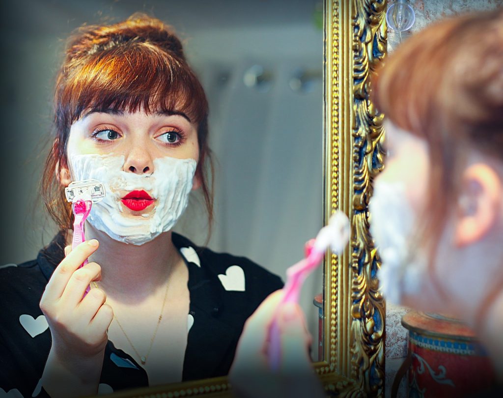 girl shaving facial hair