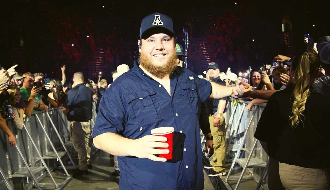 luke combs holding a disposable glass