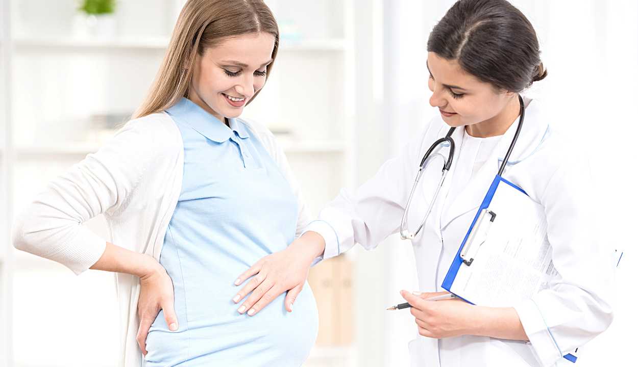 a pregnant woman with her doctor