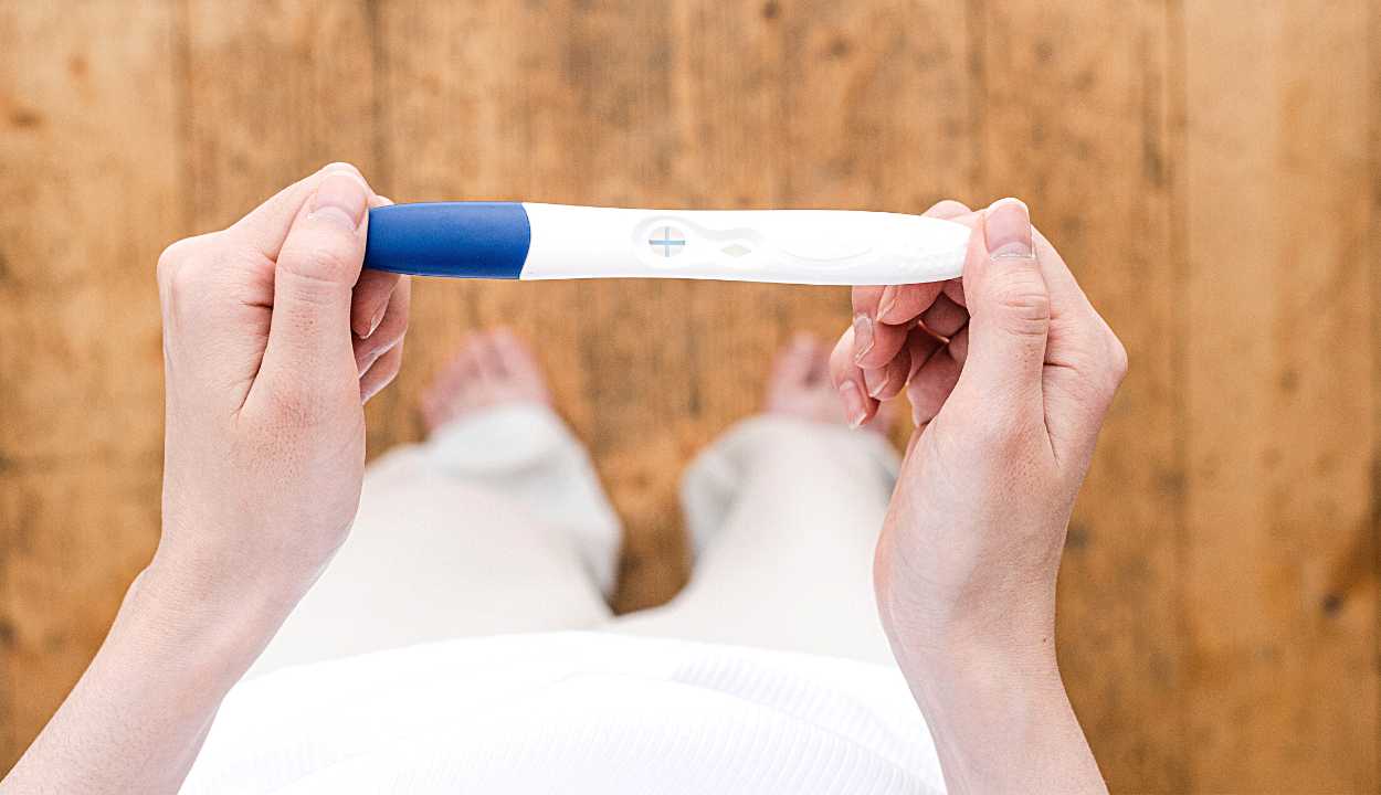 woman with a pregnancy test kit in her hand
