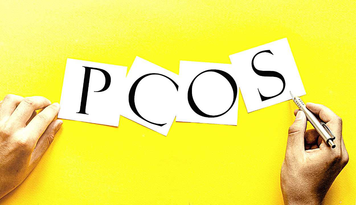 white paper with text PCOS on a yellow background