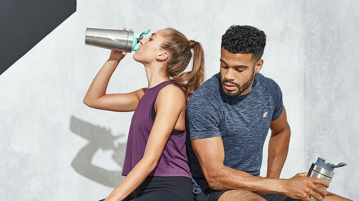 girl and boy drinking a protein shake