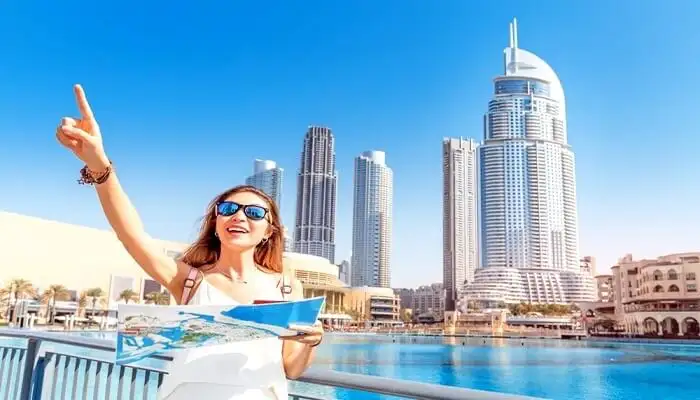 A girl with a background of Dubai sky scrapers 