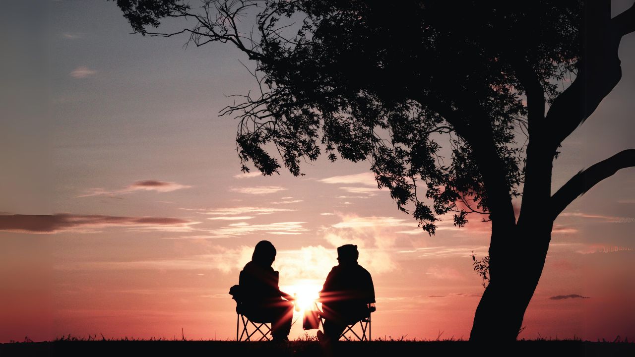 A Couple Enjoy an Evening Under the Tree